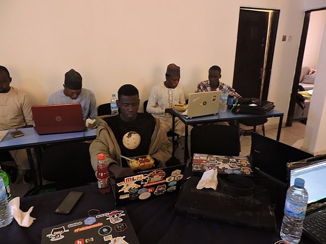 A group of Nigerian student using a laptop to create an online course as a student.